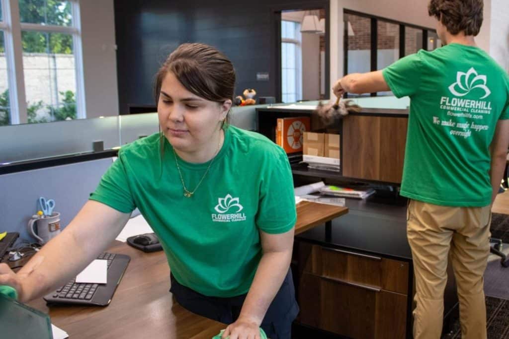 FlowerHill commercial cleaning team cleaning office desks and surfaces in Plano, TX.